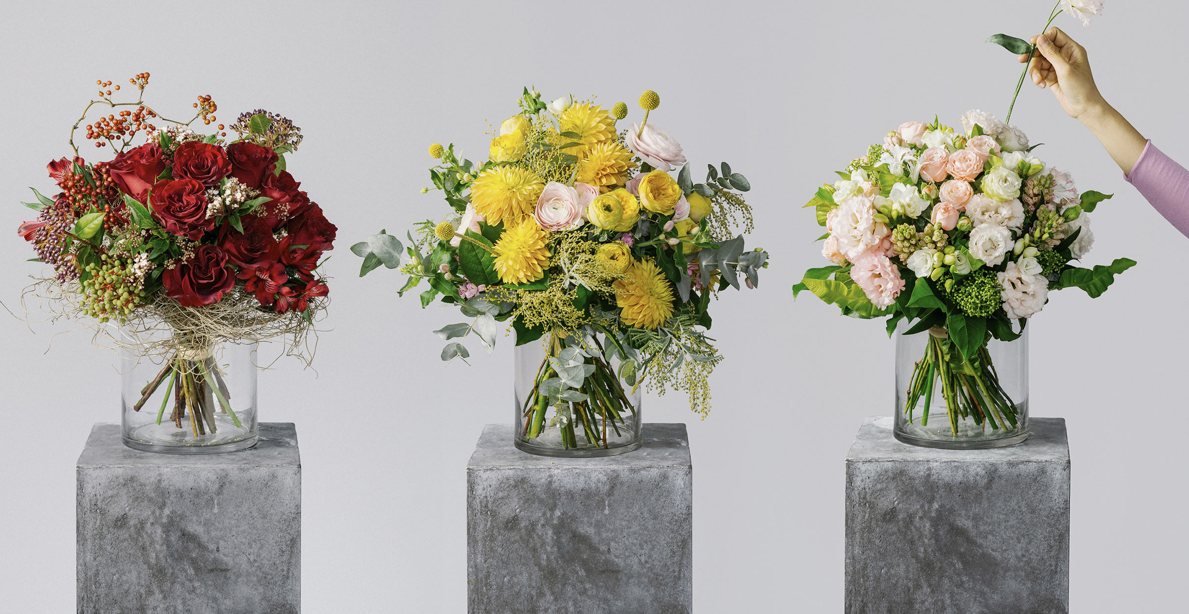 Banner image of red rose, yellow ranunculus and eustoma flower bouquets for the bespoke collection